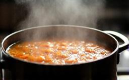 Soup simmering slowly in a large pot